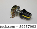 Potentiometer with knob on white background. Variable resistance. Electronic components. 89257992
