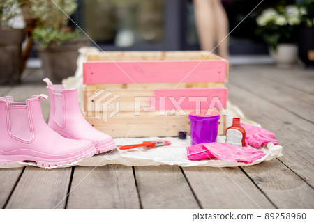 Painted wooden box with tools on terrace Painted wooden box with tools on terrace 89258960