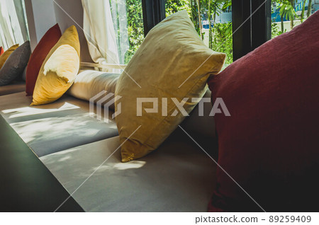 Sunlight through window on Window Seat Sofa Variety Pillows. Interior temporary style decoration idea. Sunlight through window on Window Seat Sofa Variety Pillows. Interior temporary style decoration idea. 89259409