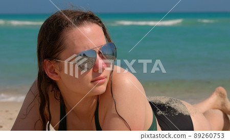 Pretty girl relaxing at the beach on her summer vacation in Florida 89260753