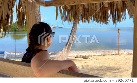 Young woman relaxing at a Caribbean beach 89260771