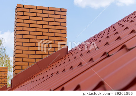 Red metal roof tile and chimney Red metal roof tile and chimney 89261896