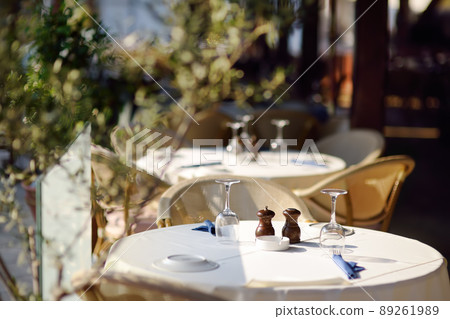 Table set in stylish outdoor cafe. Table set in stylish outdoor cafe. 89261989