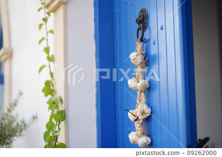 The door of a house in city of Polis in Cyprus is decorated with a bunch of garlic. The door of a house in city of Polis in Cyprus is decorated with a bunch of garlic. 89262000