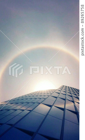 A ring of light around the sun looking up from under the building A ring of light around the sun looking up from under the building 89265758