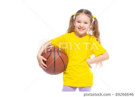 Little cute girl holding a basketball in her hand. Isolated on white background. 89266646