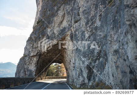Dolomites nature. An arch made of the stone on a road Dolomites nature. An arch made of the stone on a road 89269977