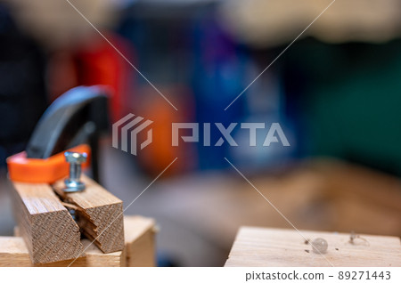 Selective focus on cracked and split wood from not drilling a pilot hole before driving a screw 89271443