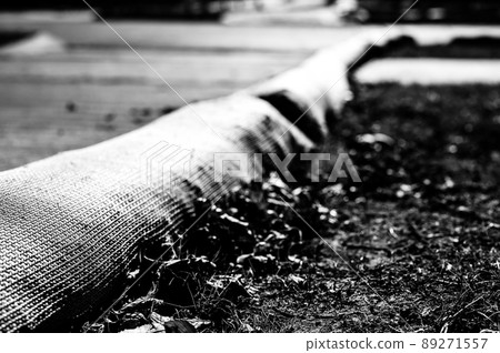 selective focus on filter sock around exposed dirt at a construction site to prevent stormwater erosion and runoff selective focus on filter sock around exposed dirt at a construction site to prevent stormwater erosion and runoff 89271557