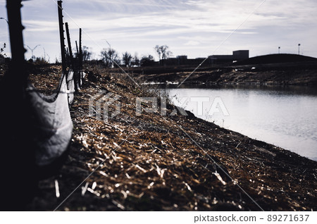 silt fence at a construction site with exposed dirt piled against the fabric 89271637