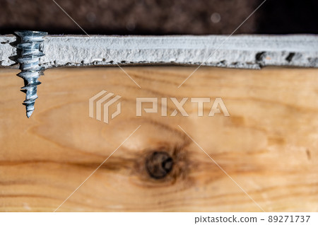 Technical depiction of how a drywall anchor is installed from a cutout side view. 89271737