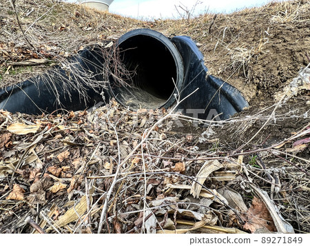 HDPE drainage culvert under a road entrance. Pipe is used to convey stormwater between ditches. HDPE drainage culvert under a road entrance. Pipe is used to convey stormwater between ditches. 89271849