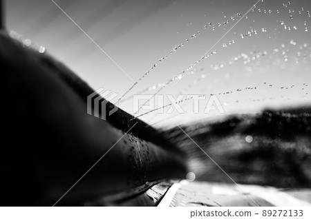 Selective focus on jets of droplets shooting out across a water slide 89272133