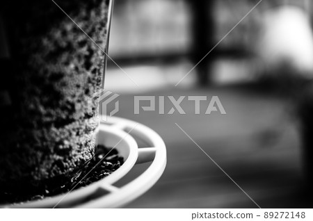Selective focus on bird feeder with mix of seeds. Residential wooden porch in blurred background. Selective focus on bird feeder with mix of seeds. Residential wooden porch in blurred background. 89272148