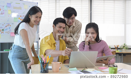 Interested happy young employees listening to male team leader explaining new online project at meeting. Interested happy young employees listening to male team leader explaining new online project at meeting. 89272980