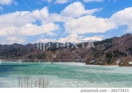 Mt. Yubari and Mt. Maedake over Shirogane Bridge in Yubari City, Hokkaido [April] 89273915
