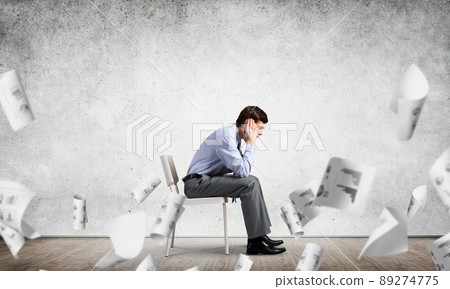 Businessman sitting on an office chair Businessman sitting on an office chair 89274775