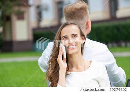 Young attractive woman talking on the phone Young attractive woman talking on the phone 89274802