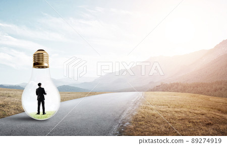Businessman inside light bulb 89274919
