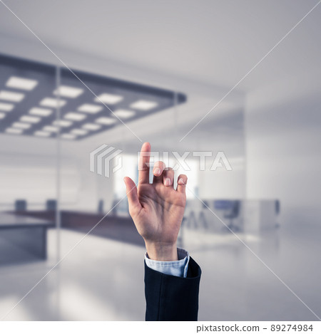 Choosing gesture of businessperson in elegant modern interior in sunshine light 89274984