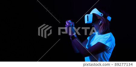 Woman with virtual reality headset is playing game. Woman with virtual reality headset is playing game. 89277134
