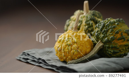 decorative pumpkins on wood table 89277491