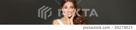 Close-up portrait of young woman face, positive view, big smile, beautiful hair in studio Close-up portrait of young woman face, positive view, big smile, beautiful hair in studio 89278625