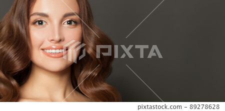 Attractive woman face. Cute model smiling on black banner background Attractive woman face. Cute model smiling on black banner background 89278628