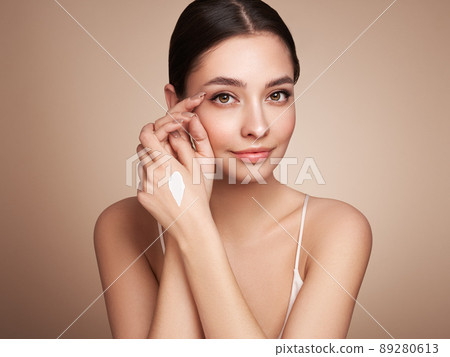 Beauty woman applying cream on her hands Beauty woman applying cream on her hands 89280613