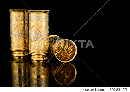 Antique Vintage Brass Shot Glass Gilded on Black background Antique Vintage Brass Shot Glass Gilded on Black background 89281455