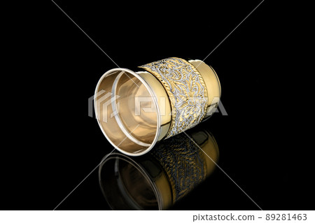 Antique Vintage Brass Shot Glass Gilded on Black background Antique Vintage Brass Shot Glass Gilded on Black background 89281463
