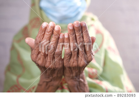 senior women with face mask hand praying at ramadan senior women with face mask hand praying at ramadan 89283093