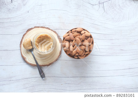 almond butter spread and nuts on table, top view almond butter spread and nuts on table, top view 89283101