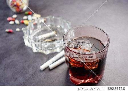 alcohol, pills and cigarette on table alcohol, pills and cigarette on table 89283138