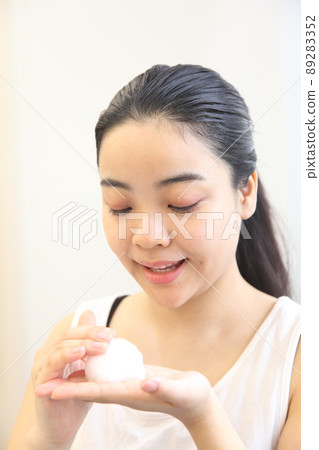 Young woman picking up bubbles Young woman picking up bubbles 89283352