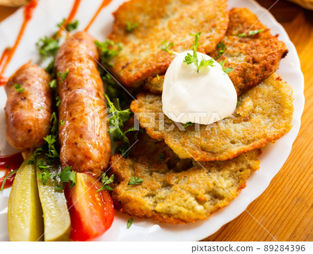 belarusian pancakes with sausages in a restaurant 89284396