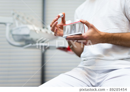Dentist doctor holding teeth implant model in his hands Dentist doctor holding teeth implant model in his hands 89285454