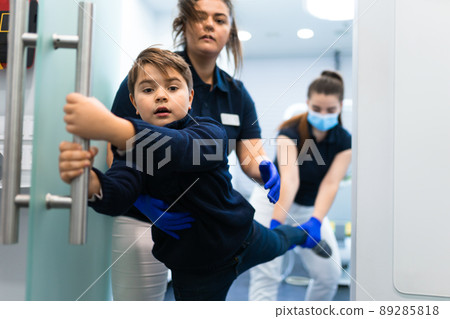 Scared teenager trying to escape from the dentist's office. Fear of doctors concept 89285818