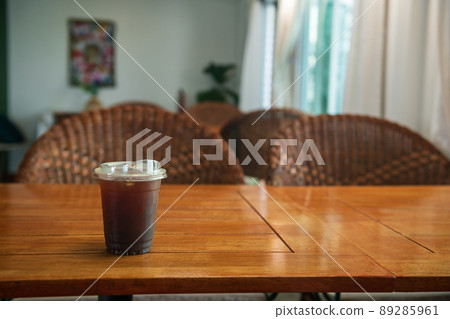 Ice Americano black coffee on wooden table at cafe Ice Americano black coffee on wooden table at cafe 89285961
