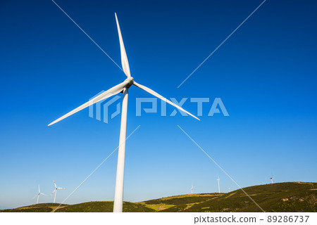 Turbines in a mountain wind farm. Ecological energy production. Turbines in a mountain wind farm. Ecological energy production. 89286737