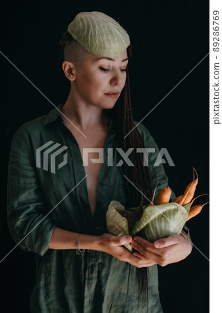 Creative portrait of vegan woman holding vegetables. Veganism, vegetarianism, plant-based diet 89286769