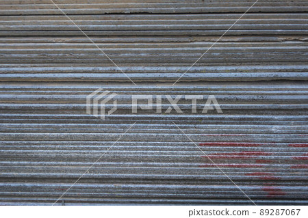 A pack of old slate, view from the side. Gray background from slate stripes. A pack of old slate, view from the side. Gray background from slate stripes. 89287067