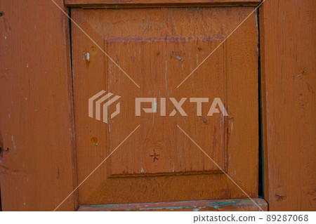 Element of an old red painted cracked door Element of an old red painted cracked door 89287068