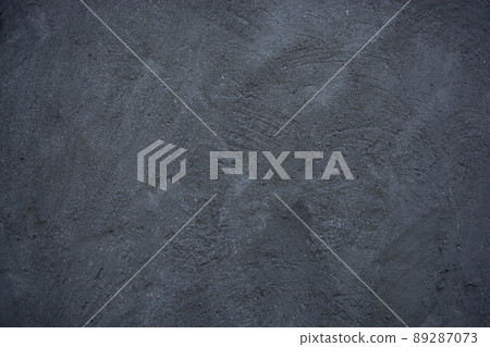 Gray dark concrete wall with bumps and scratches. Gray dark concrete wall with bumps and scratches. 89287073
