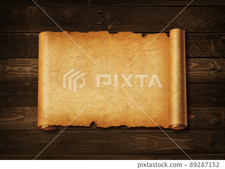 Old mediaeval paper sheet. Horizontal parchment scroll on a wood board Old mediaeval paper sheet. Horizontal parchment scroll on a wood board 89287152
