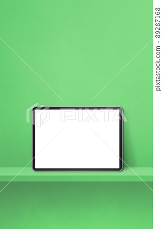 Digital tablet pc on green wall shelf. Vertical background banner Digital tablet pc on green wall shelf. Vertical background banner 89287168