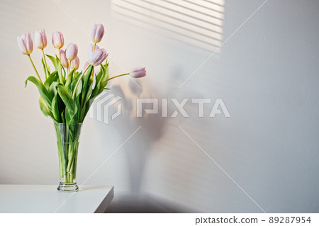 Mother day mockup tulip flowers. Minimal Banner mockup with lilac tulip flowers on white table and light wall background. Bouquet of delicate spring tulips in a minimalist style 89287954
