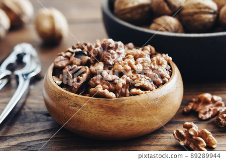 Shelled walnuts, nutcracker and bowl of nuts on kitchen table. Shelled walnuts, nutcracker and bowl of nuts on kitchen table. 89289944