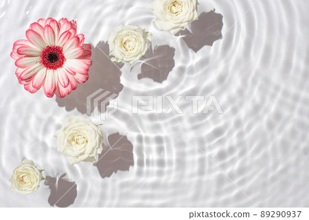 Sunny summer cosmetic background with flowers. The texture of the water surface. Sunny summer cosmetic background with flowers. The texture of the water surface. 89290937