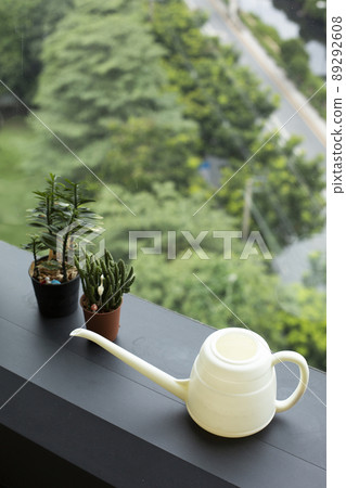 Watering can and houseplants decoration near window Watering can and houseplants decoration near window 89292608